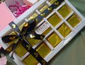 Box of gold velour chocolates with a black ribbon on a light green background
dubai viral kunfa choclate